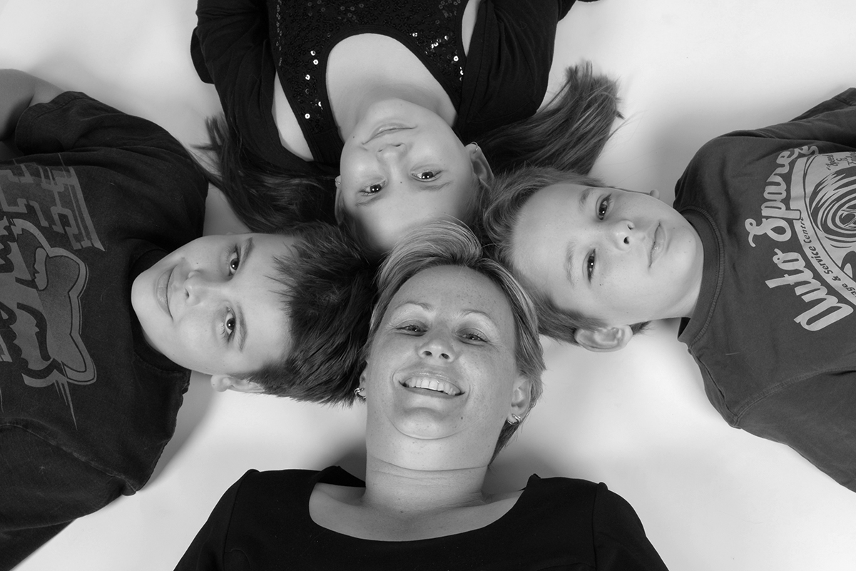 black and white photo of mother and three children