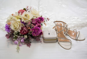 wedding shoes, necklace, wedding bouquet and bridal gown dress
