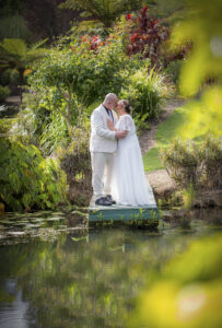 bridal couple kissing lakeside Maleny wedding photography