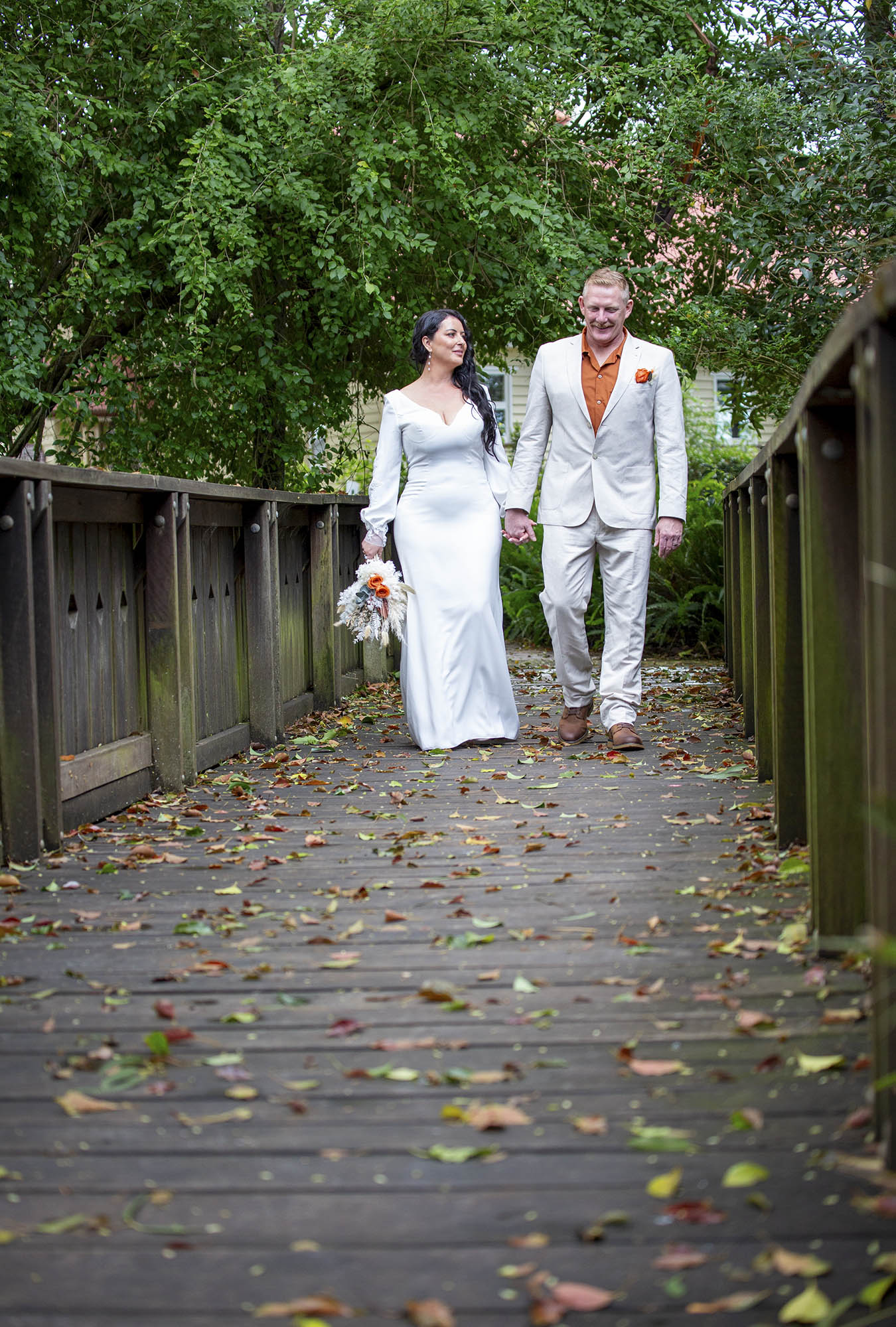 Bridal-cpouple-walking-bridge-footpath-Malenyweddingphotography bridal couple walking footpath over bridge Maleny wedding photography