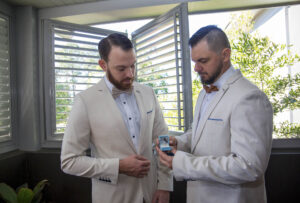 best man and groom looking at wedding rings Maleny wedding photography