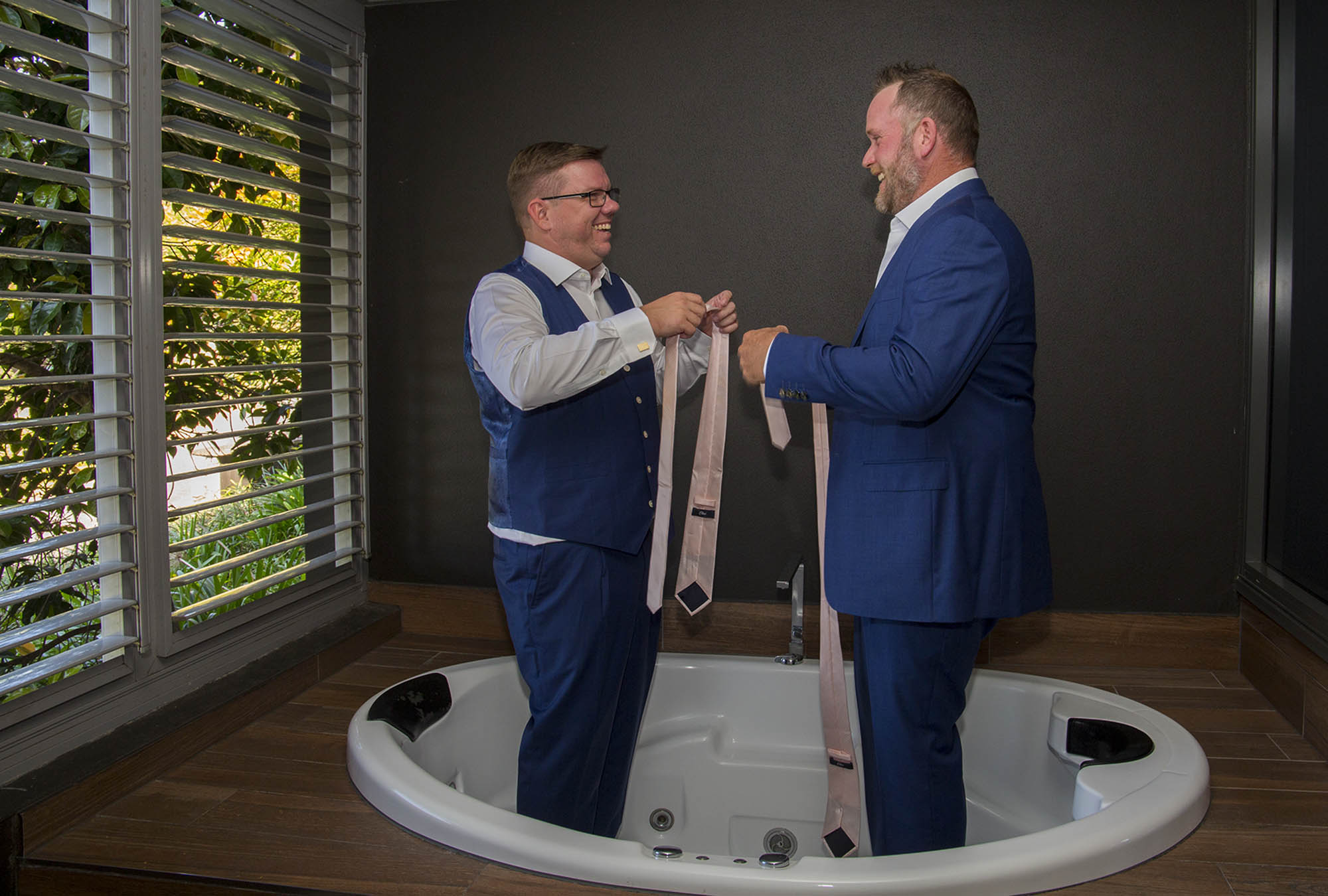 groom-best-man-standing-spa-tub-Malenyweddingphotography groom and best man standing in spa bath Maleny wedding photography