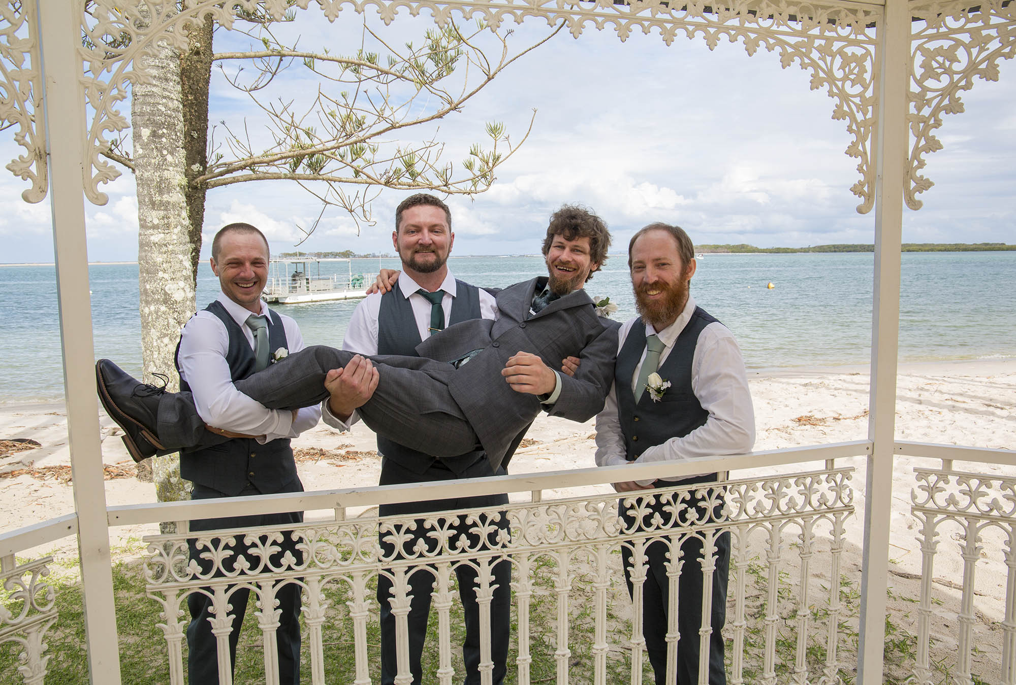 groom-held-by-grromsmen-rotunda-Malenyweddingphotography groom being held by groomsmen at wedding Rotunda Maleny wedding photography